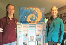 Anneli and Mathilde Macdonald, 8th graders at Jacoby Creek School, stand in front of their first-place project about nitrogen isotopes in tree rings. Photo: courtesy of Sierra Club.